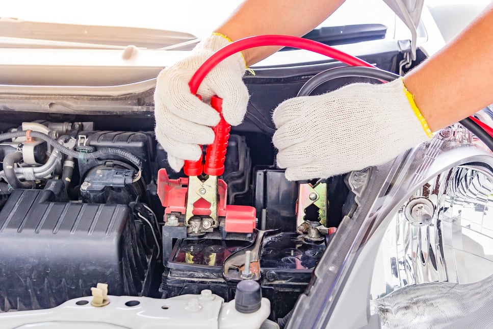 Mechanic Jumpstarting a Car Battery